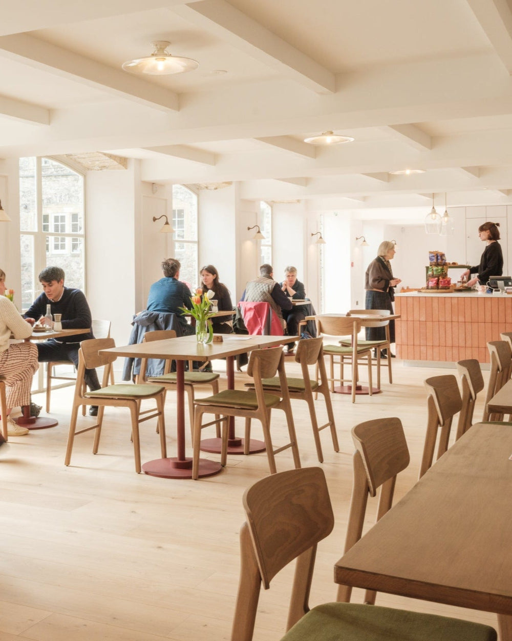 A photo of people sat in the Kilver cafe enjoying food and drinks