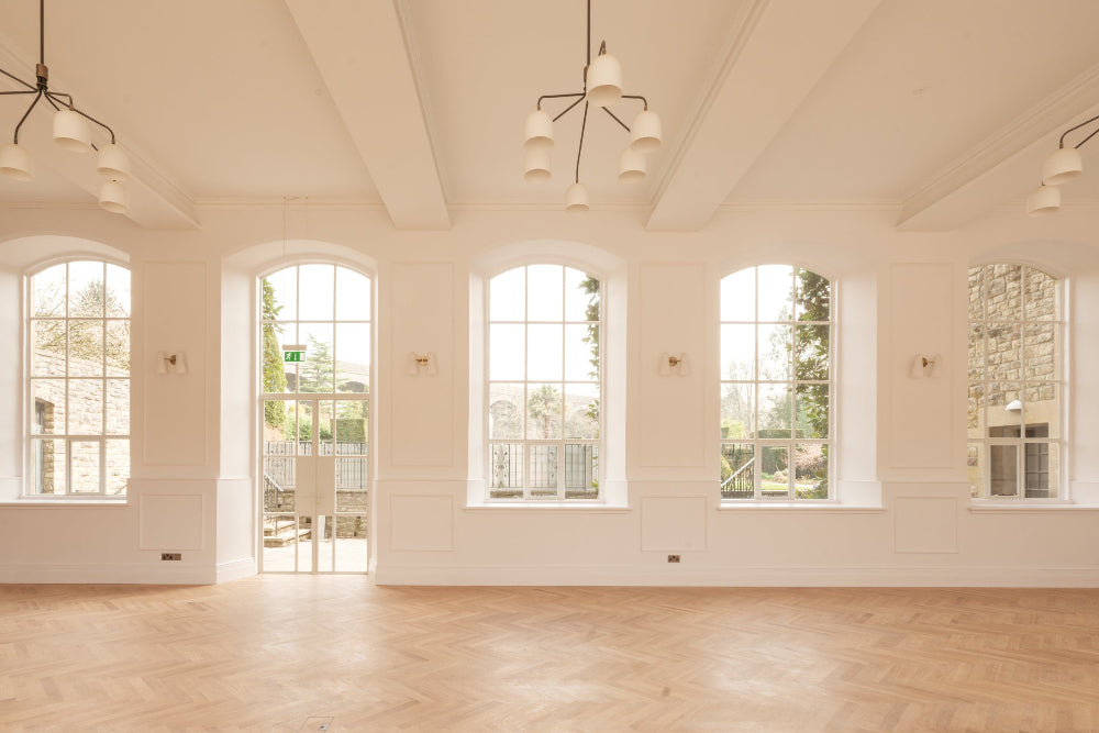 A view of the white ballroom at Kilver Court, with natural light coming through the large windows