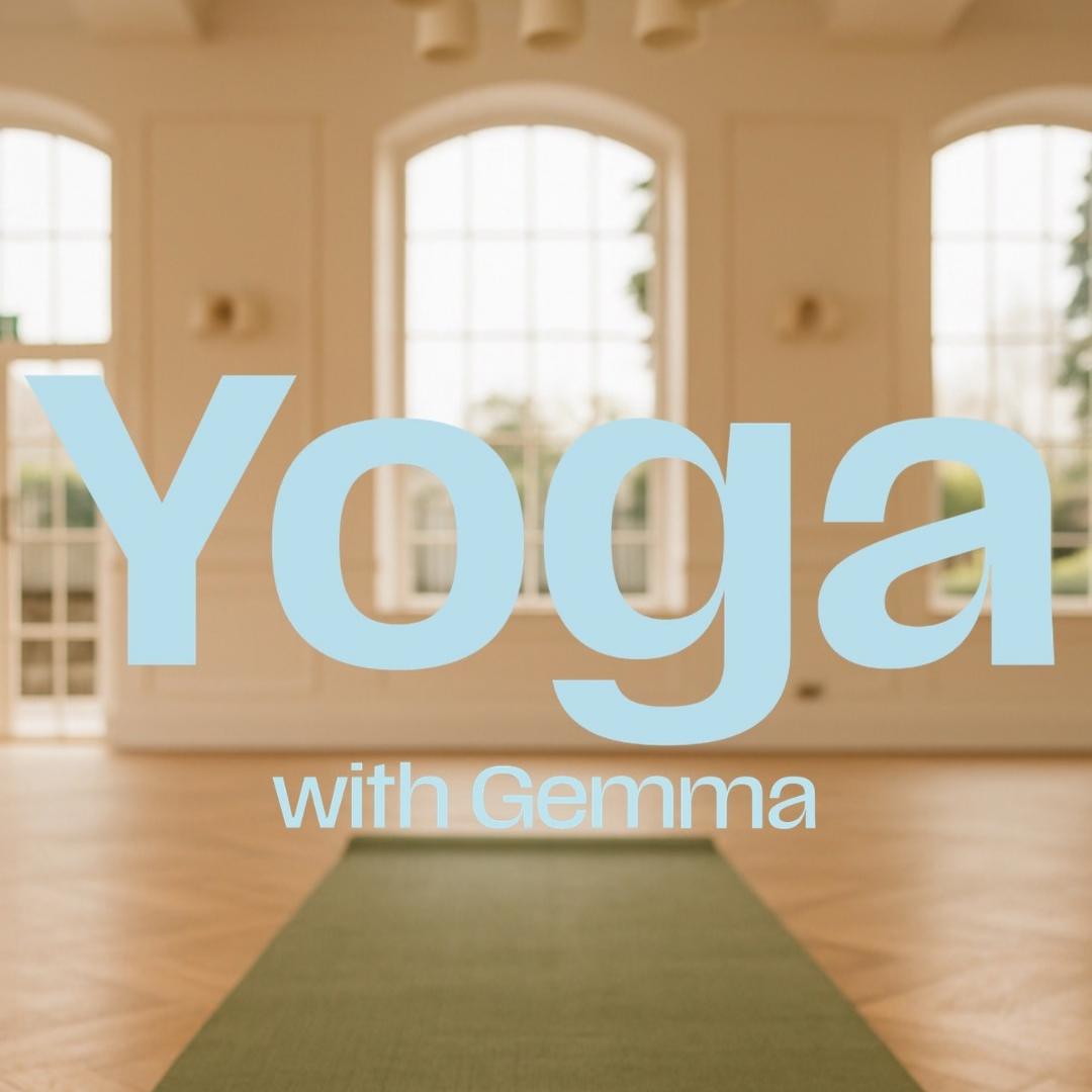 A large light blue text overlay reading 'Yoga with Gemma' is centered over a softly blurred indoor yoga studio scene with arched windows, warm beige walls, wood flooring, and a green yoga mat on the floor.